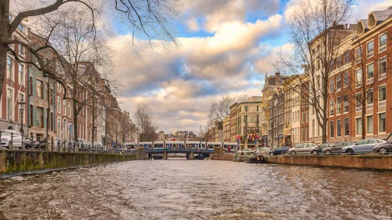 Narrow canal houses reflected in Amsterdam's Herengracht canal at dusk