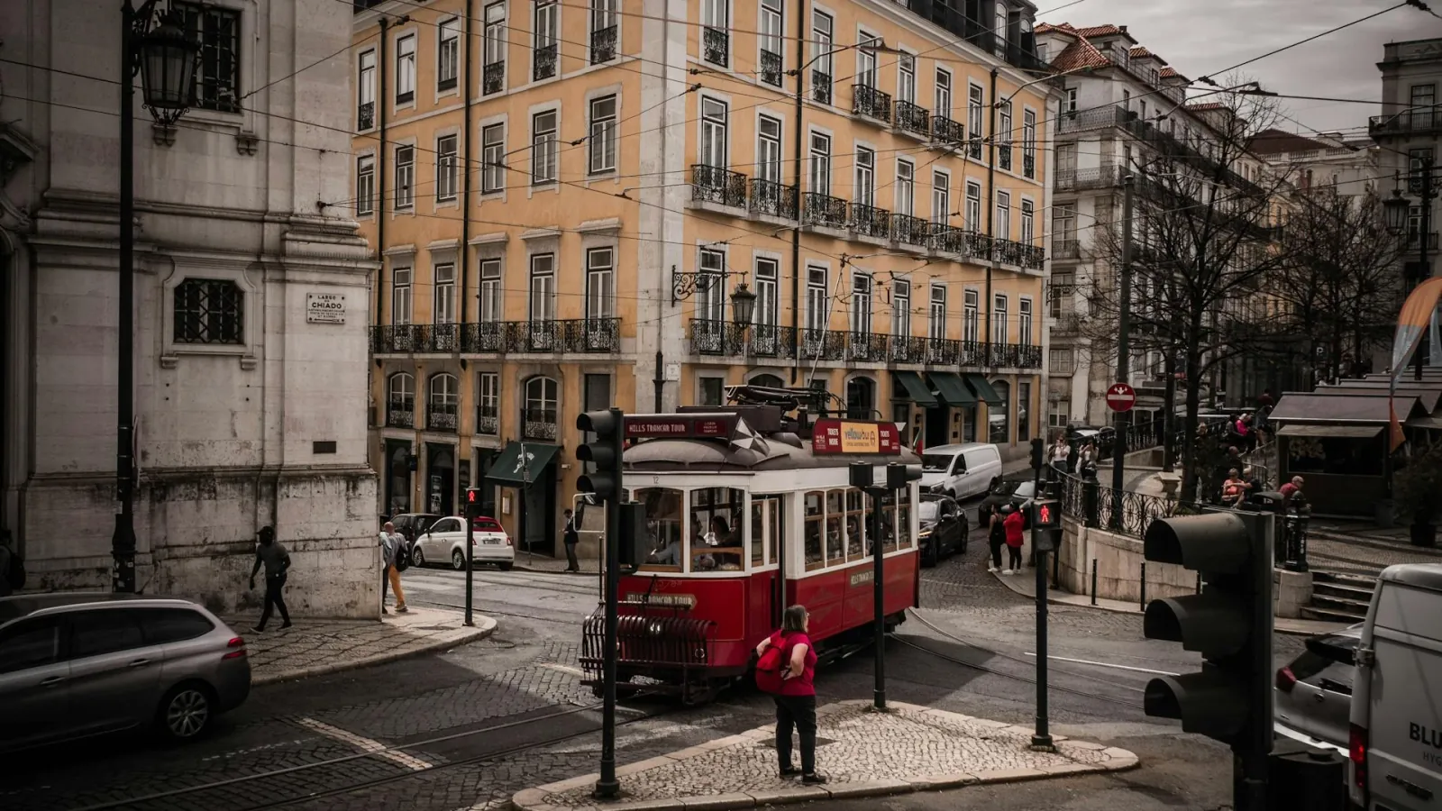 Lisbon tram on cobblestone street versus Barcelona Sagrada Familia — Portugal vs Spain comparison